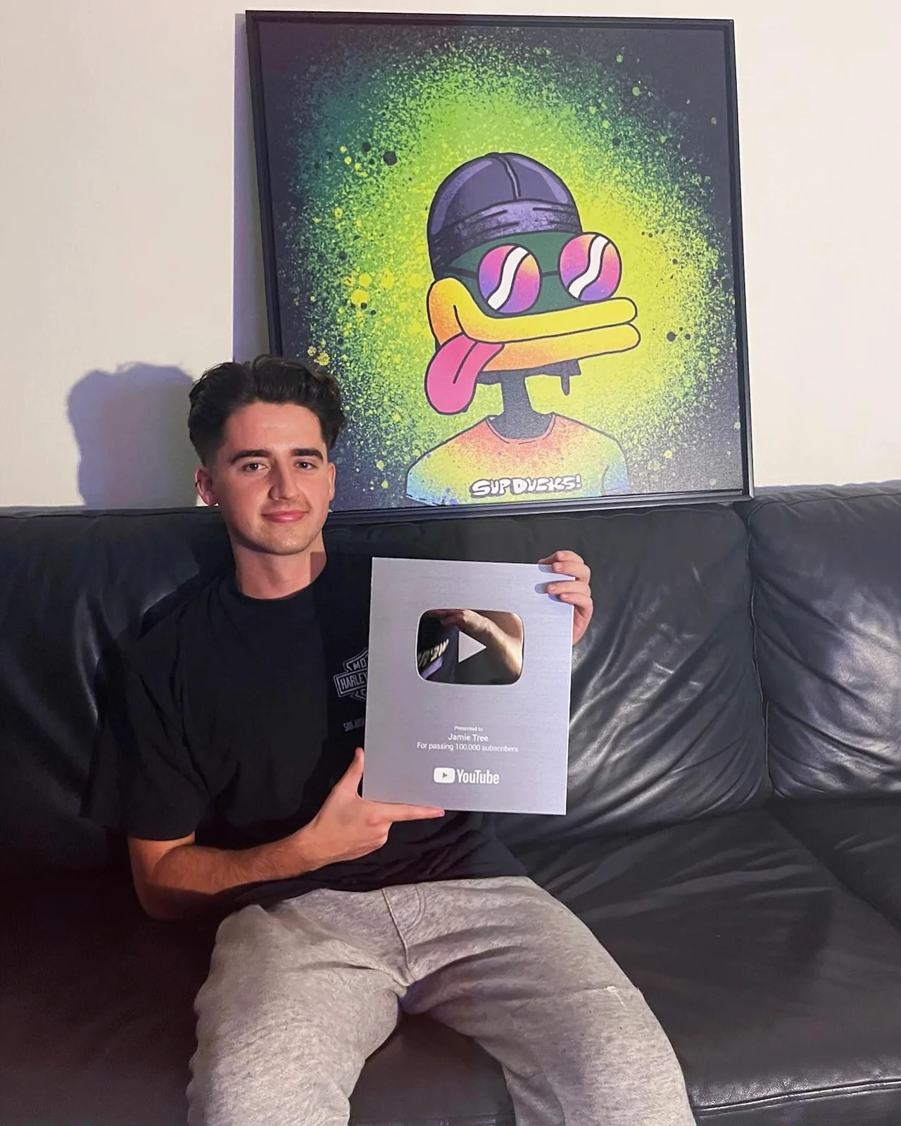 Holding the YouTube silver play button