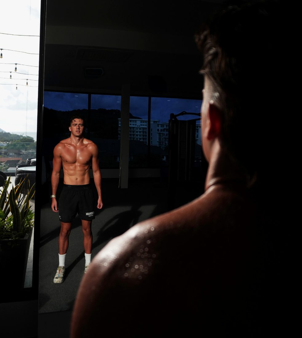 Jamin in a dark gym, reflected in the glass